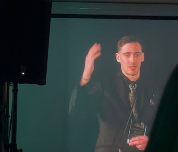 Jason Shipway accepting the 2025 BGCCI Business Excellence Award on stage