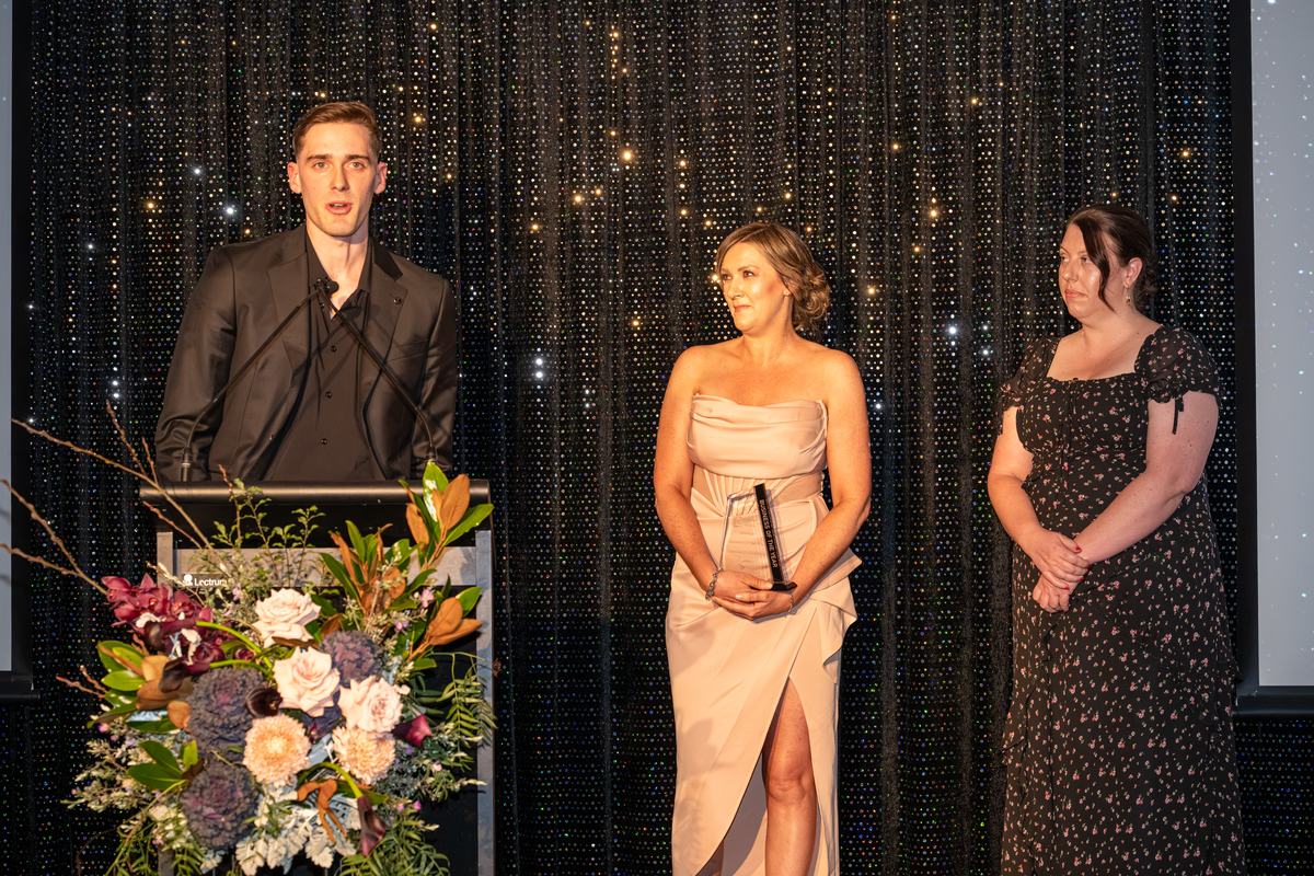 Jason Shipway accepting the 2026 Business of the Year award on stage for Enhanced Cleaning